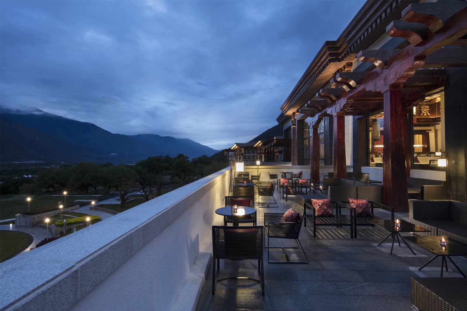 Terrace lounge at dusk overlooking the mountains at Hilton Nyingchi Resort