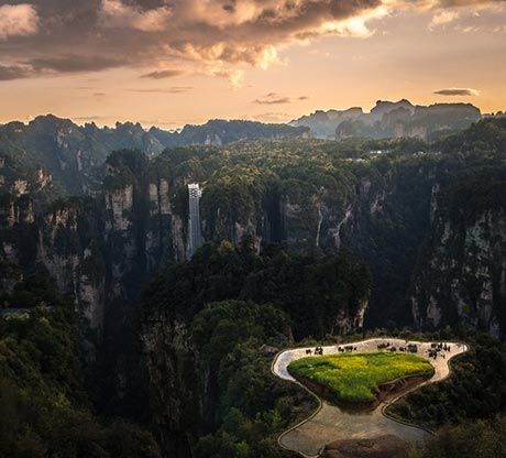 Sunlit rock pillars of Yuanjiajie rising through morning mist