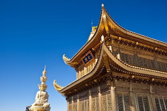 Golden pavilion and Buddha statue at the summit of Mount Emei