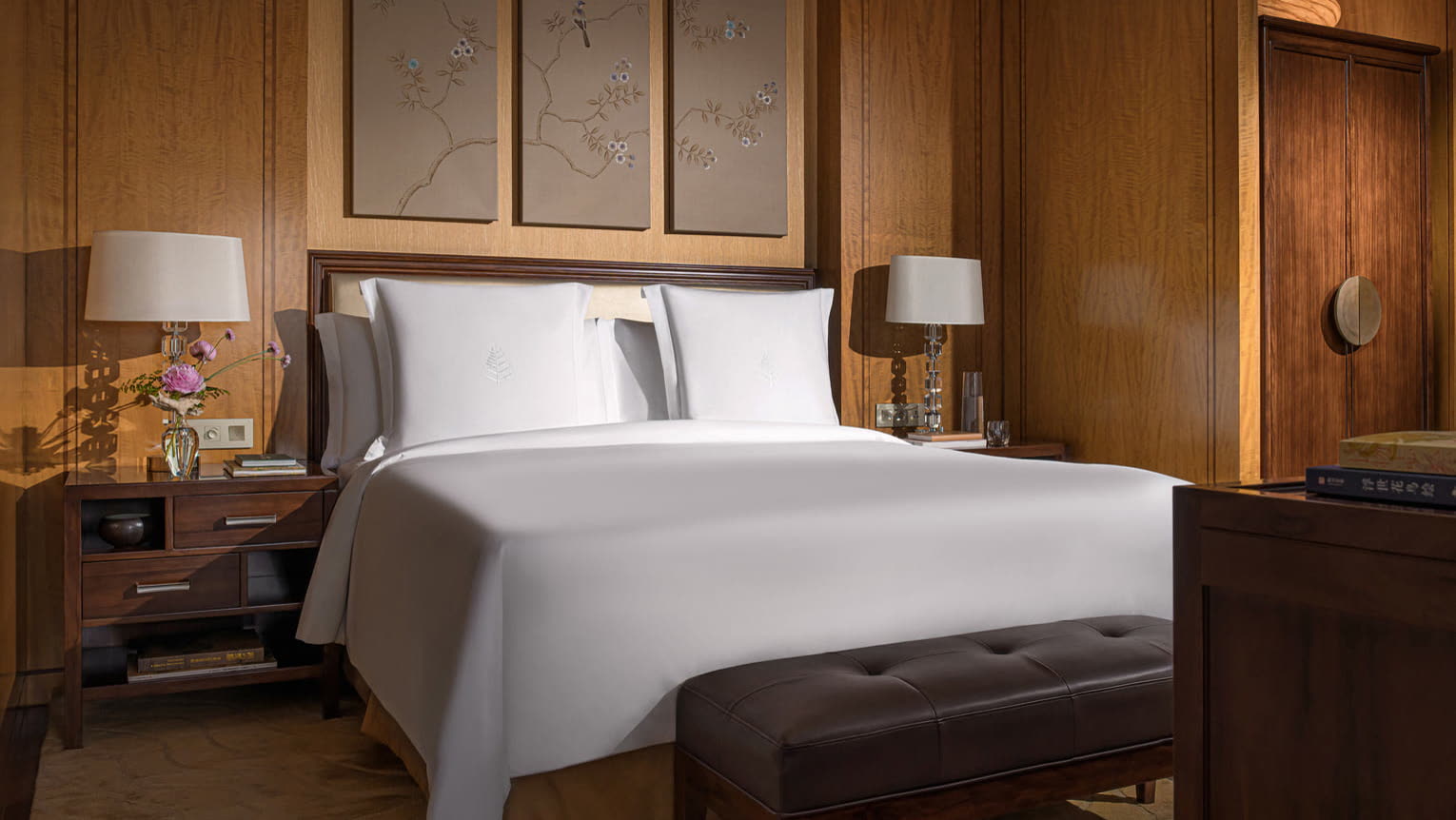 Timber-panelled guest bedroom with embroidered silk panels at Four Seasons Hotel Hangzhou