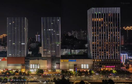 Crowne Plaza Yichang towers lit at night above Wanda Plaza