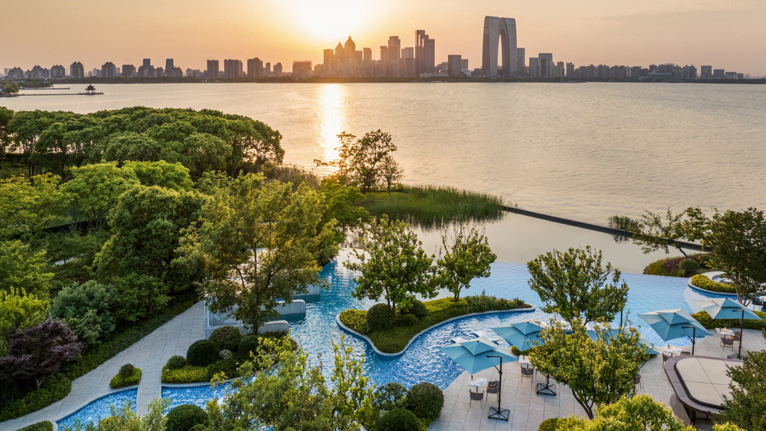 Lagoon pool at sunset with the Suzhou skyline beyond