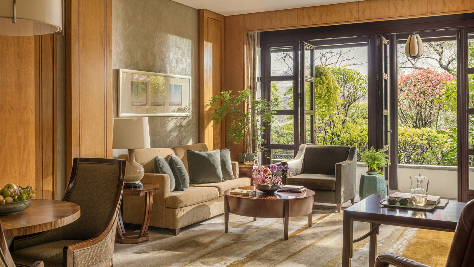Garden-facing living room of a suite at Four Seasons Hotel Hangzhou