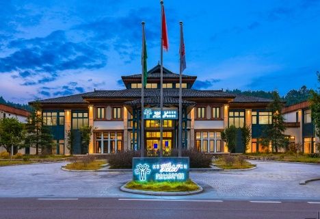 Xiaoqikong Ruijing Hotel entrance lit at dusk