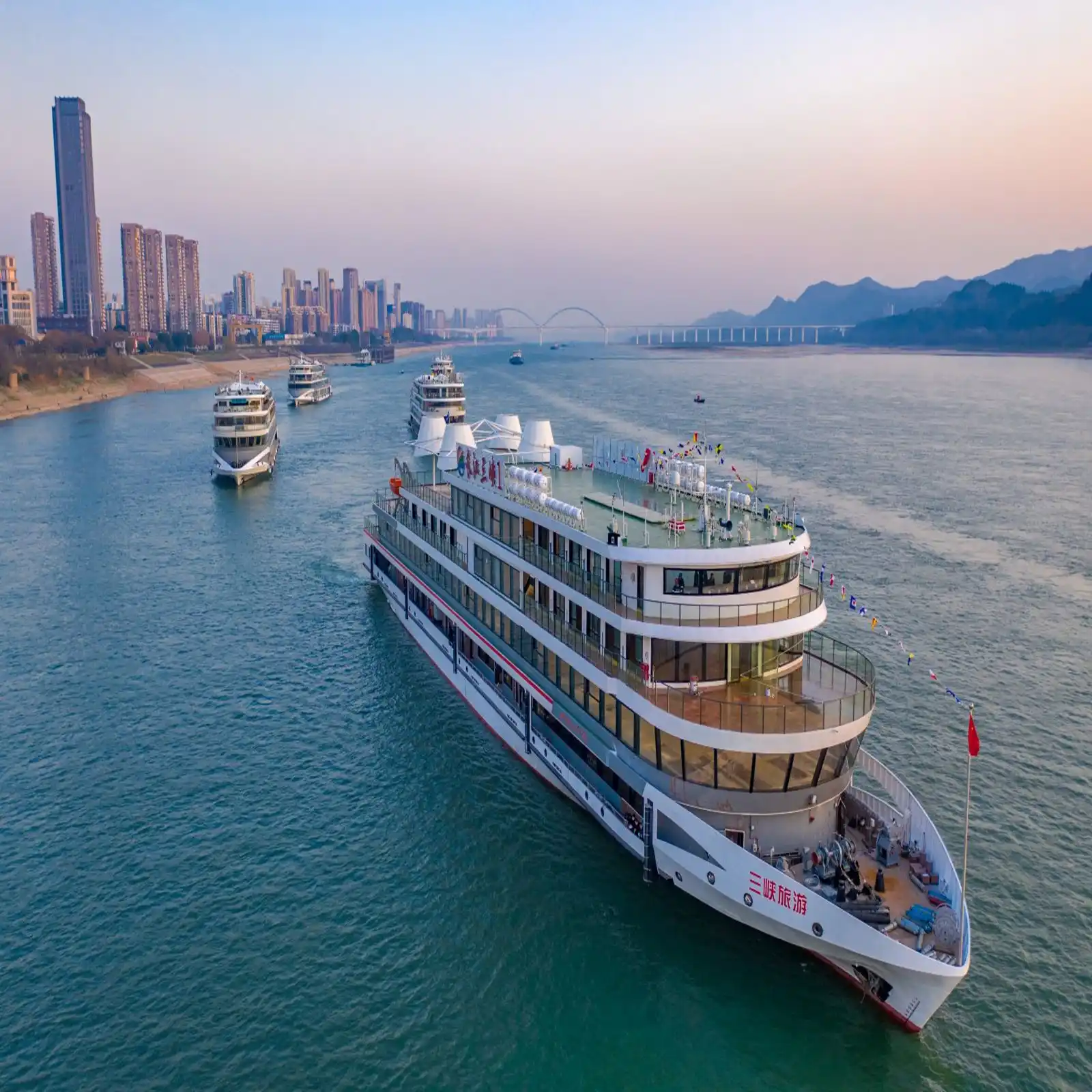 Cruise ships on the Yangtze River at Yichang, city skyline behind