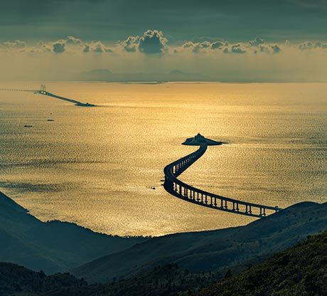 The Hong Kong-Zhuhai-Macau Bridge over the sea at golden hour