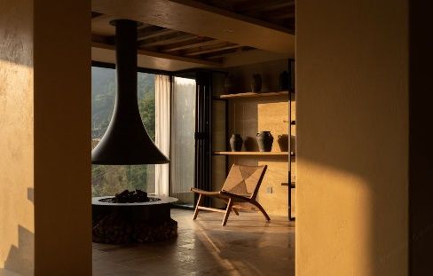 Fireplace lounge with hillside view at Wuwei Shanshe Homestay