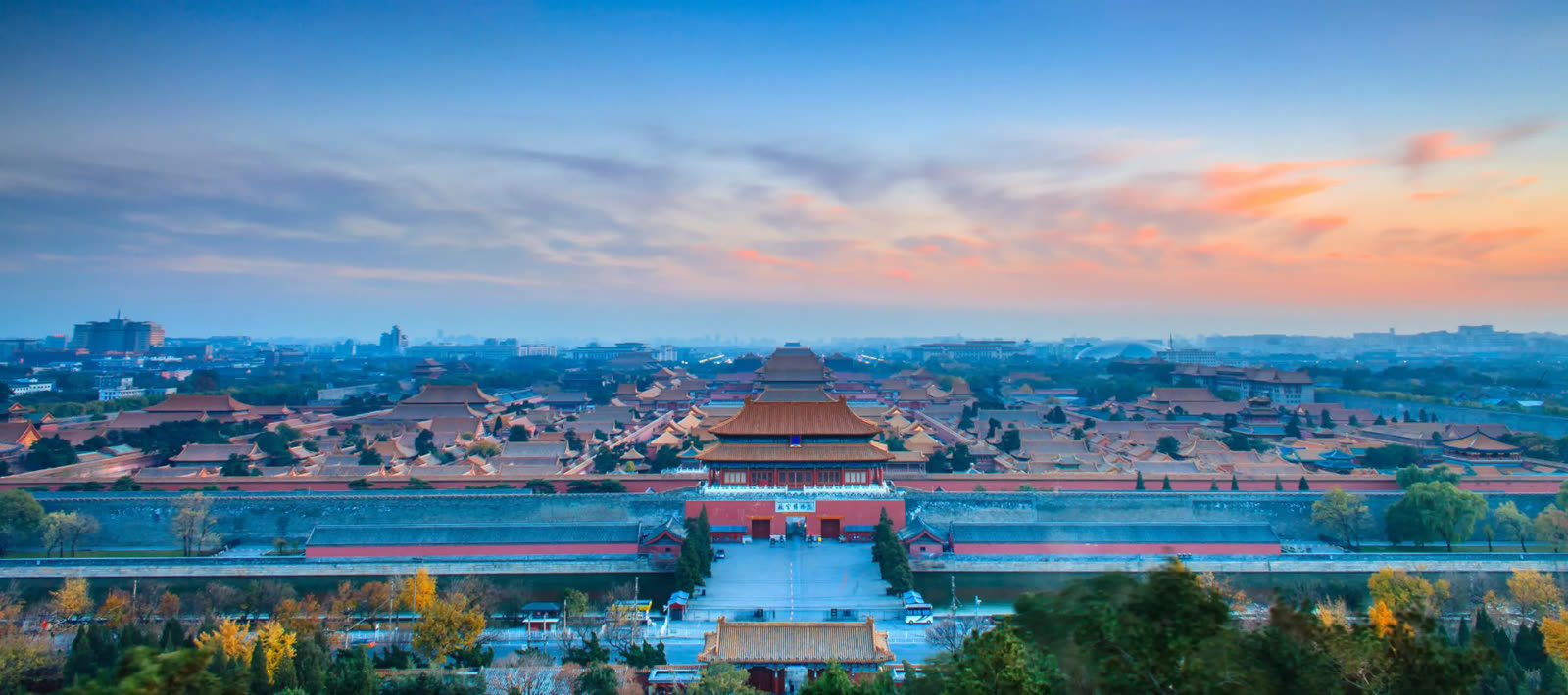 View across the golden roofs of the Forbidden City at sunrise