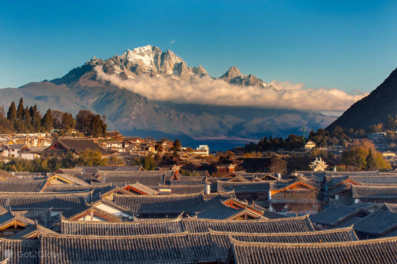 Lijiang's old town rooftops with Jade Dragon Snow Mountain behind