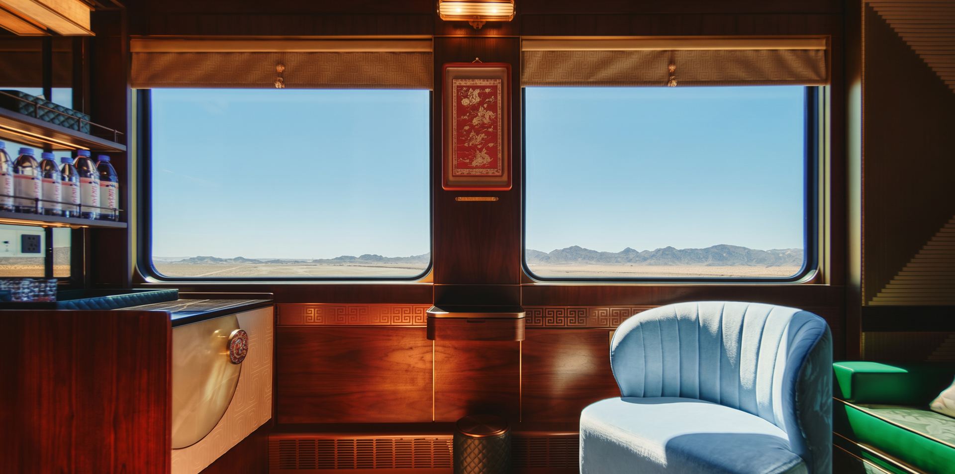 Travelers in a private observation carriage looking out at misty karst mountains at sunrise